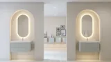 Stilvolle und moderne Badezimmer Inspiration mit ovalen Spiegeln mit Lichtsteuerung, Steinwaschbecken und Waschtischunterschränken mit eleganten Rillen in einem minimalistischen Design, helle und luftige Atmosphäre, elegante Beleuchtung