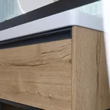 Badezimmerinspiration mit langen blauen Fliesen, Badezimmermöbeln aus naturbelassener Eiche mit schwarzen Details, die einen harmonischen und raffinierten Ausdruck schaffen