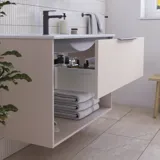 Inspiration für ein Badezimmer mit rosafarbenem Waschtischunterschrank mit eleganten Rillen und schönem Waschbecken, weißen Fliesen an den Wänden und großen beigen Fliesen auf dem Boden, die einen romantischen und femininen Look erzeugen.