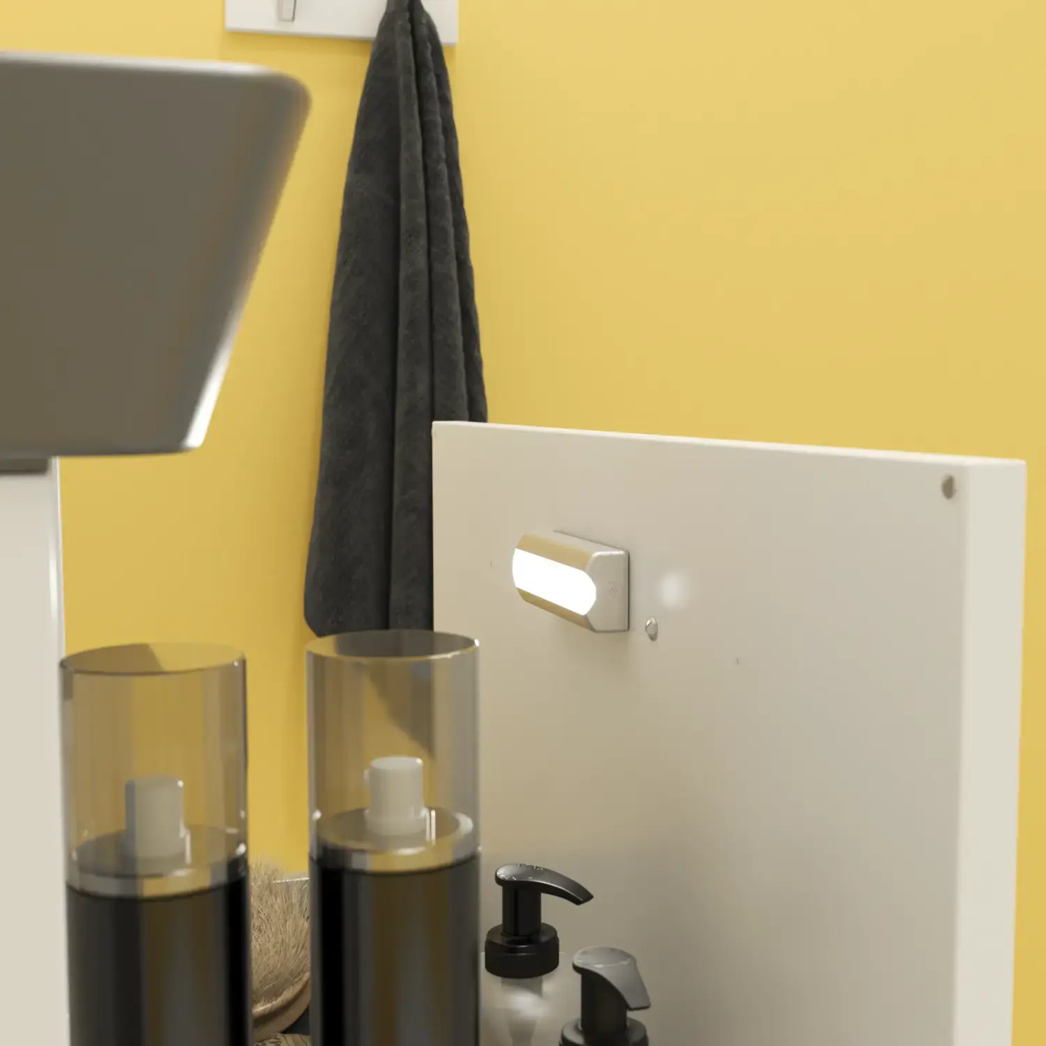 Kleine Badezimmerinspiration mit weißem Waschtisch mit schwarzem Griff und schwarzem elegantem Waschbecken, schönem rundem Spiegel mit schwarzem Rand, Terrazzo-Wand und -Boden und gelben Wänden für einen mutigen und modernen Look.